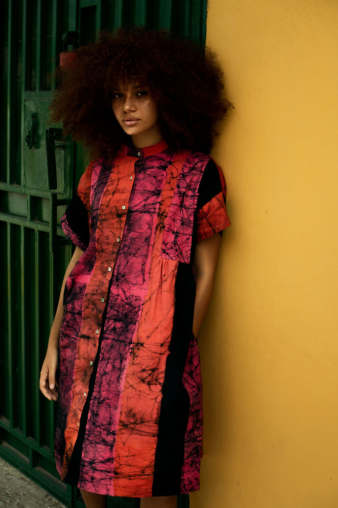 Vibrant Bata Dress in Carmine print against yellow backdrop, highlighting the colorful and lively design.