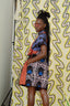 Stylish woman in vibrant Bata dress with eye-catching colorful print design.