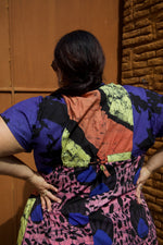 Close-up back view of the oversized Bata Dress with a tie in the back to sinch the waist.