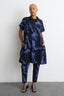 Modern Bata Dress in blue and black, oversized shirt style, abstract print, neutral setting.