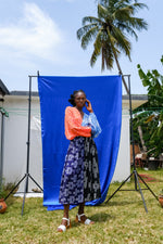 Stylish Bating Dress against a blue outdoor backdrop, showcasing a patterned skirt and two-tone sleeves.