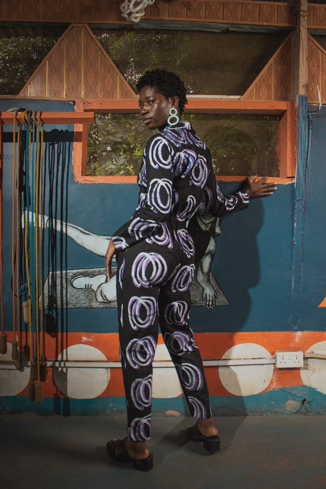 Accra Jumpsuit in Good Signal print, side view with drawstring waist, hand-dyed cotton, made in Ghana.