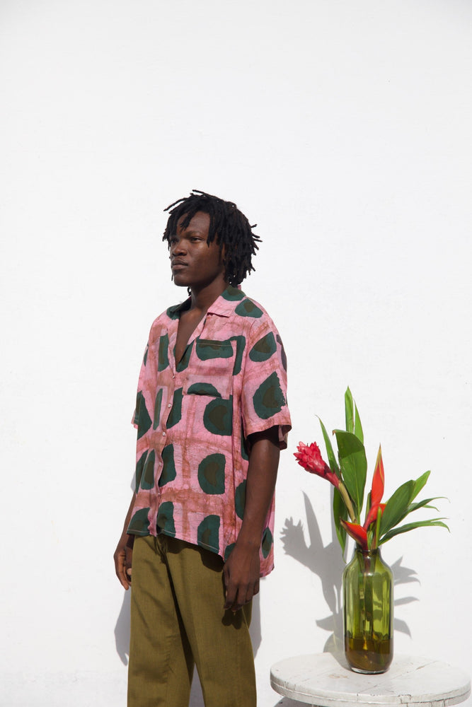 A vibrant unisex shirt made of rayon in size 2 featuring a colorful pink print with green shapes resembling avocados.