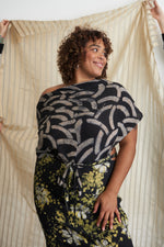 Katharos Dress in Nap Time print, a unique wrap top and bottom, against curtain backdrop, embodying grace and adaptability.