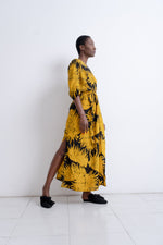 Captivating Letsa Dress in Aden print, mid-step motion against a white backdrop, highlighting the lively print.