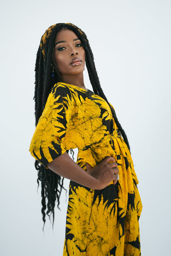Letsa Dress in Aden print, vibrant yellow with black leaf patterns, exemplifying hand-dyed craftsmanship.