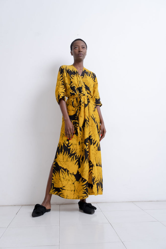 Letsa Dress in Aden print, a long wrap with side slits, batwing sleeves, and deep V neckline, in hand-dyed yellow and black.