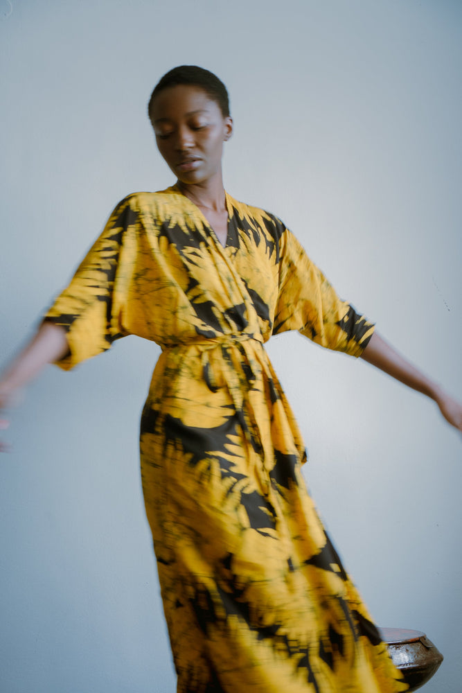 Flowing Letsa Dress in Aden print captures a sense of movement, with wide sleeves and a cinched waist.