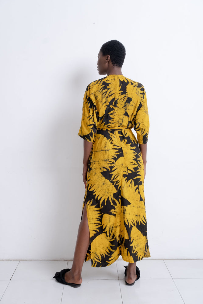 Letsa Dress in Aden print, back view highlighting the wrap waist, side slit, and batwing sleeves against a white backdrop.