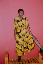 Letsa Dress in Aden print, outdoor elegance with batwing sleeves and wrap-around waist tie, hand-dyed in Ghana.