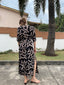 Back view of a woman wearing the Letsa wrap dress in the Cantaloop print, featuring side slits for added flair and comfort.