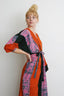 Vibrant Letsa wrap dress in multicolored robe style, wide sleeves, tied at waist with black sash, against a white background.