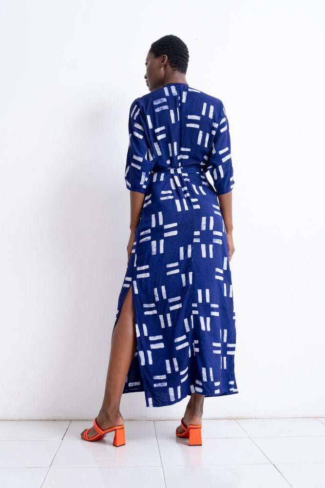 Elegant Letsa Dress in Middle Path, blue with white rectangle print, long sleeves, and side slit, paired with orange heels.