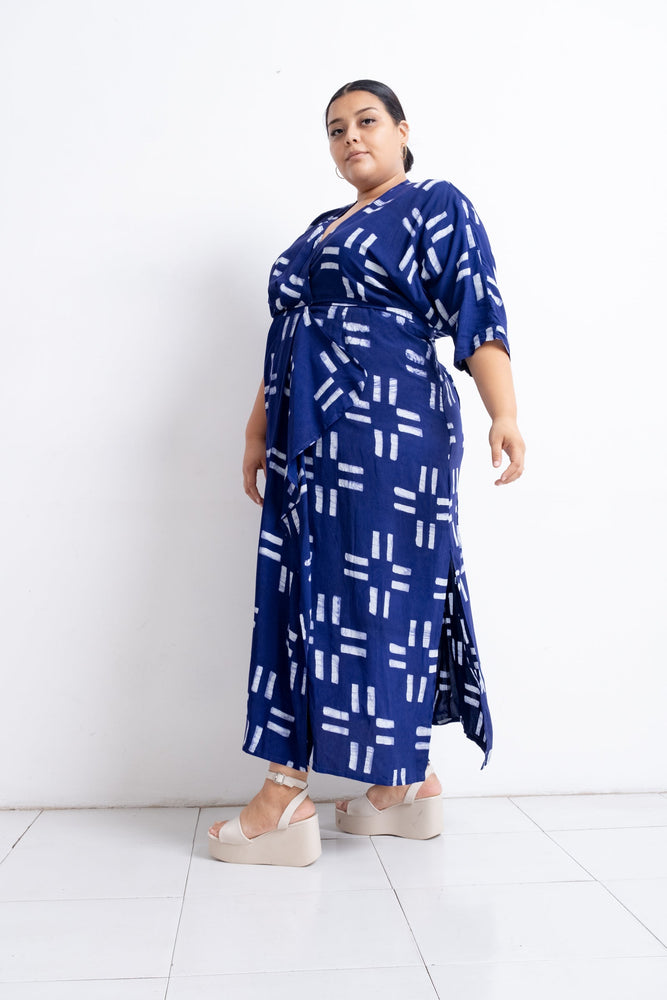 Letsa Dress in Middle Path print, blue with white rectangular pattern, wrap-around style, paired with white platform sandals.