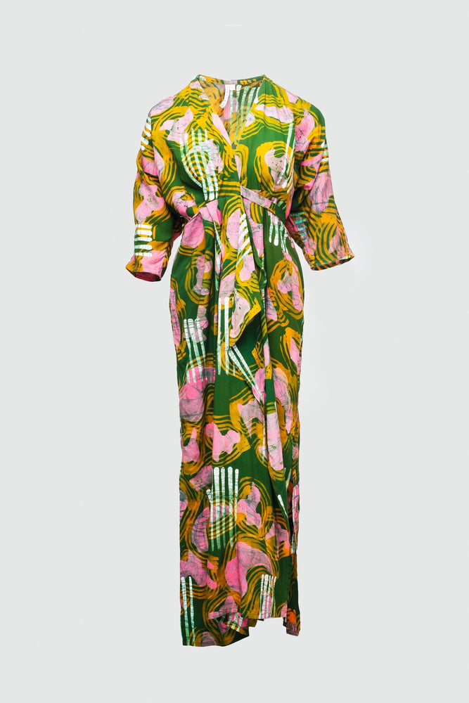 Vibrant Letsa dress displayed against grey backdrop, showcasing bold green print with pink and white accents.