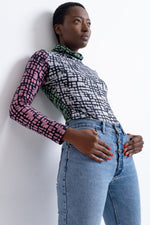 Vibrant cotton Stricta Turtleneck in Carnival print, featuring pink, green, white and black batik design, made in Ghana.