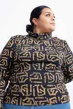 Fitted Stricta Turtleneck in Chale print with abstract black lines on a light background, handcrafted in Ghana.