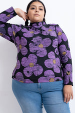 Person in Stricta Turtleneck in Love Perfect print and blue jeans, showcasing the vibrant purple floral pattern.