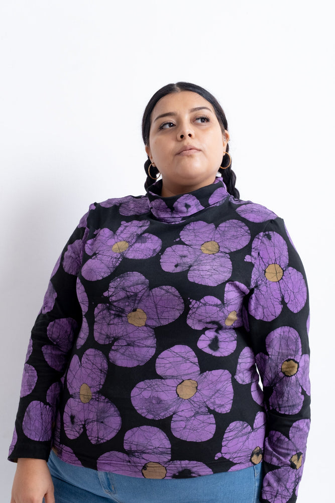 Person in Stricta Turtleneck in Love Perfect print, showcasing the vibrant and detailed batik floral design.