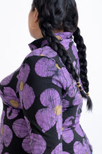 Close-up of Stricta Turtleneck in Love Perfect print, showcasing playful purple daisies on black.