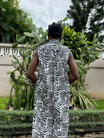 Back view of the Tropicana Dress in Long Division without the belt worn, the woman is standing in front of cacti.