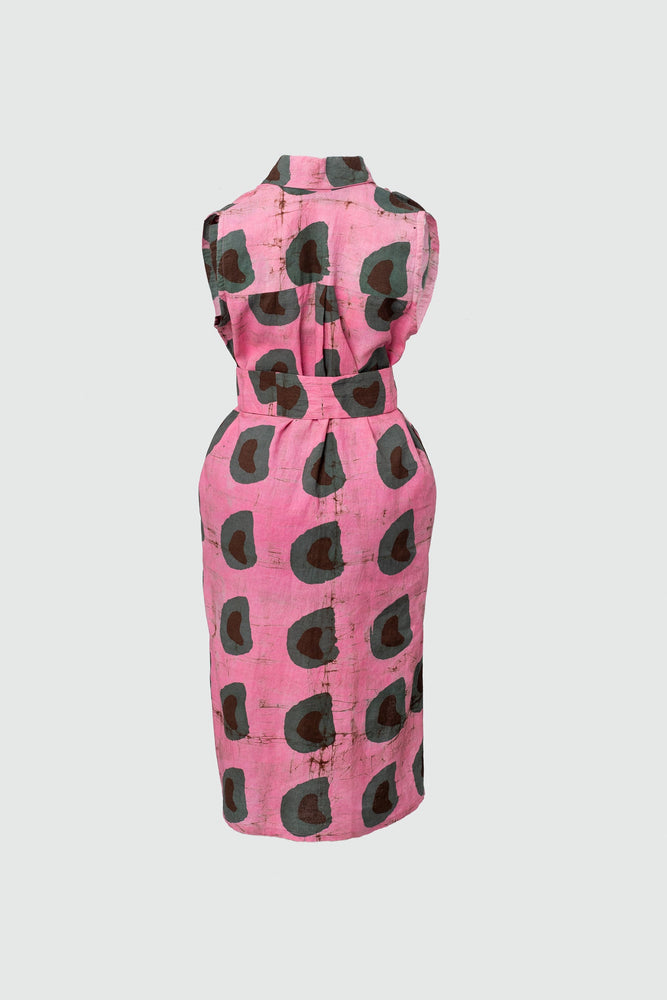 Back view of a cotton sleeveless shirtdress with A-line skirt, a batik dyed pink dress with abstract dark green shapes.