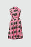 Front view of a cotton sleeveless shirtdress with A-line skirt, a batik dyed pink dress with abstract dark green shapes.