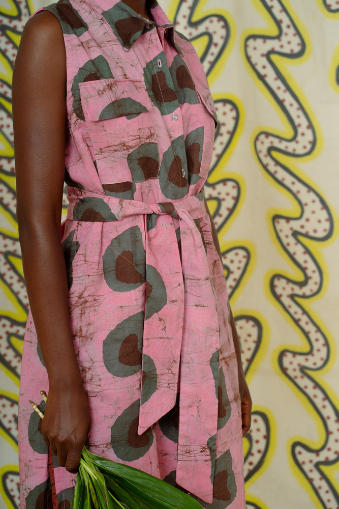 A close up of the cotton Tropicana Dress showcasing the breast pockets and sash belt in the vibrant Tunnel of Love print.