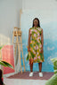 A vibrant A-line dress with a colorful print in shades of green and pink. Featuring a collar, button front, and pockets.